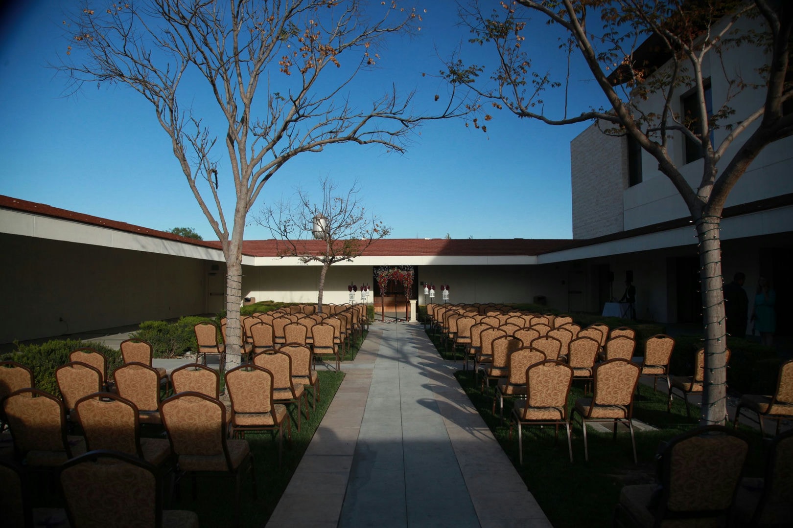 An outdoor patio area with rows of chairs.