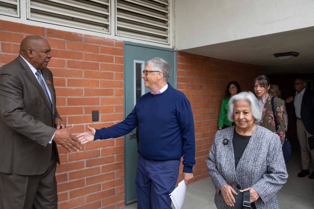 Bill Gates shakes the hand of Chaffey College Governing Board President Lee McDougal.