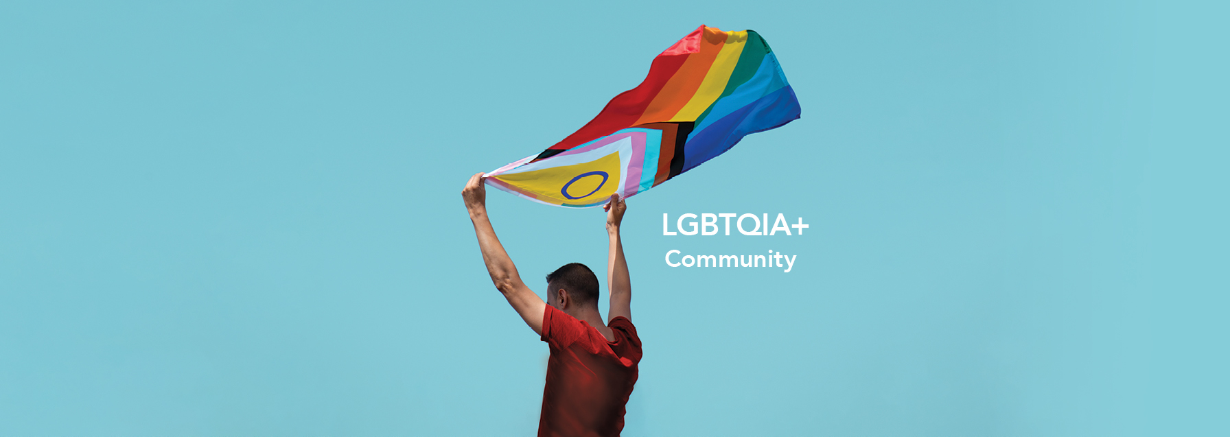 man holding a progressive flag with lgbtqia community