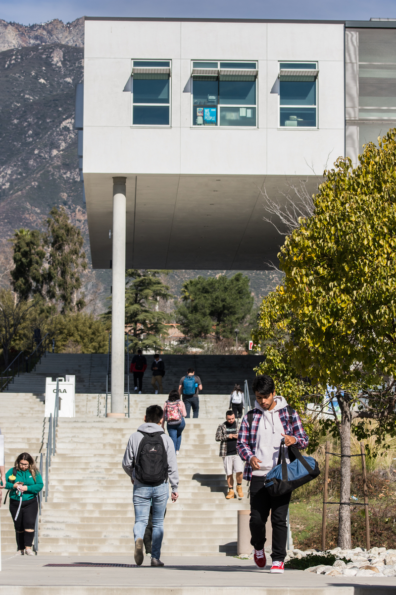 Student walking up the stairs to CAA building